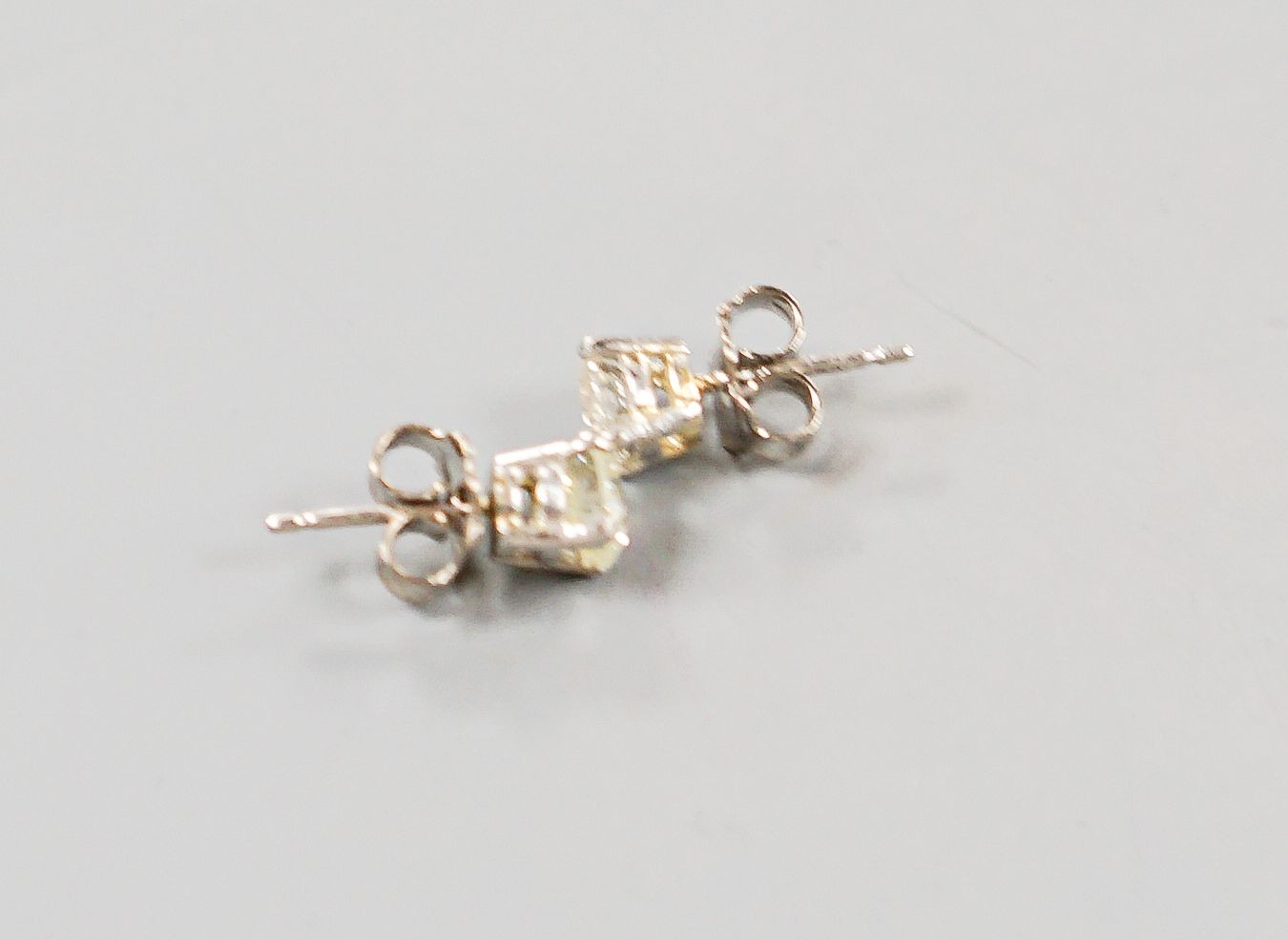 A pair of 750 white metal and solitaire diamond ear studs, gross weight 2.3 grams